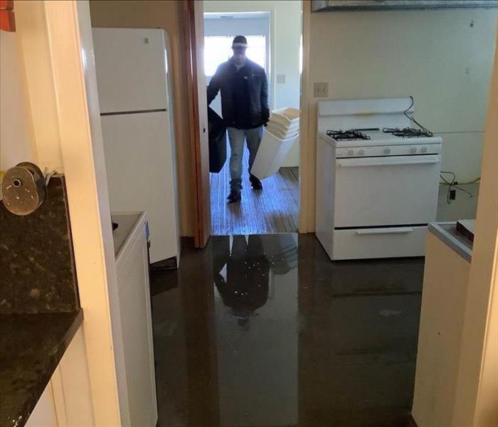 SERVPRO crew in flooded commercial building